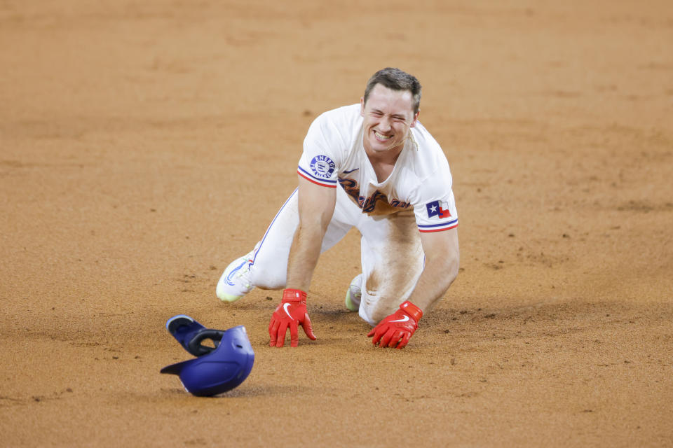 Texas Rangers' Wyatt Langford trips as he rounds second base during the second inning of a baseball game against the Seattle Mariners, Wednesday, April 24, 2024, in Arlington, Texas. (AP Photo/Gareth Patterson)