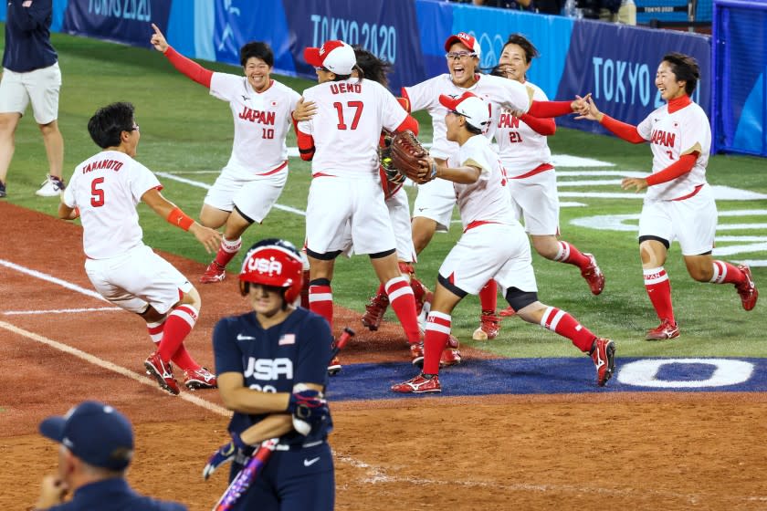 Team Japan celebrate a 2-0 win over the USA Women's Softball team for the Gold Medal.