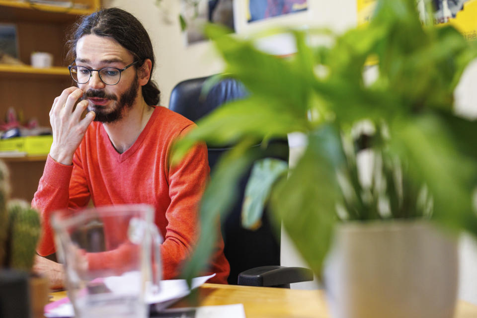 Clement Valentin, legal advocacy officer for the CIRE Refuge Group works at his desk in Brussels, Tuesday, Jan. 31, 2023. Many refugees and asylum-seekers are literally left out in the cold for months as the European Union fails to get its migration system working properly. And most talk is about building fences and repatriation instead of working to improve a warm embrace for people fleeing nations like Afghanistan where the Taliban has taken over. (AP Photo/Olivier Matthys)