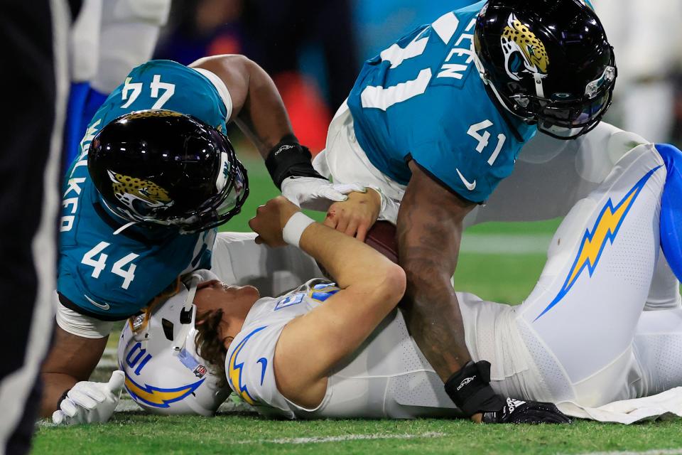 Jaguars' outside linebackers Travon Walker (44) and Josh Allen (41), seen here combining to sack Los Angeles Chargers quarterback Justin Herbert in an AFC wild-card game, had a pedestrian year as pass-rushers and that's part of the reason why the defense didn't reach its potential.