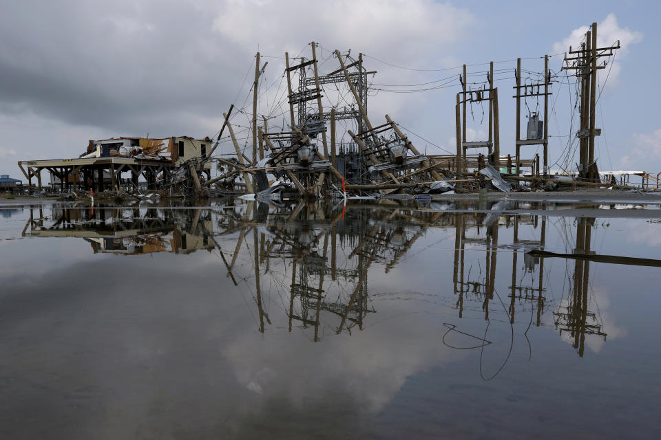 Image: Damaged power lines and homes in Grand Isle, La. (Leah Millis / Reuters file)