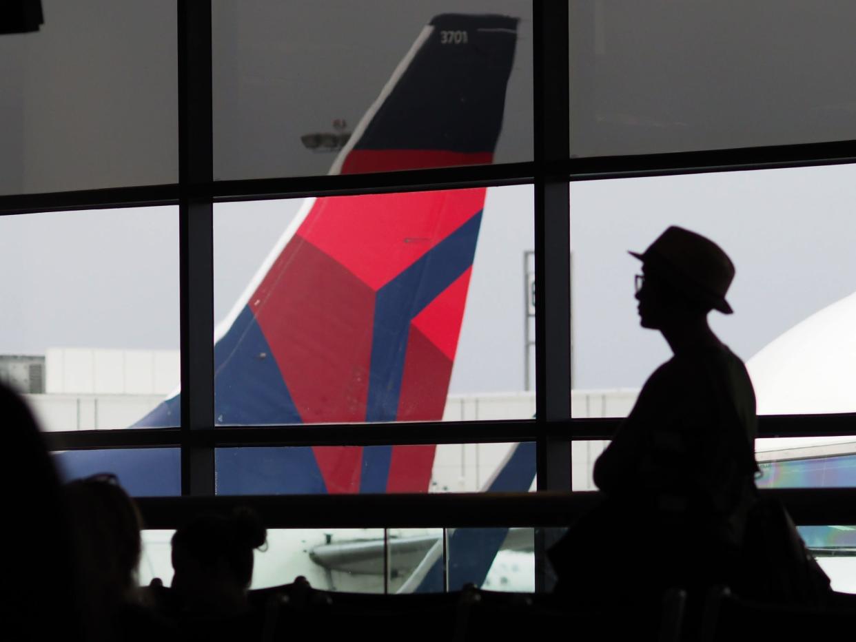 A passengers waits for a Delta Airlines flight in Terminal 5 at Los Angeles International Airport, May 4, 2017 in Los Angeles, California.