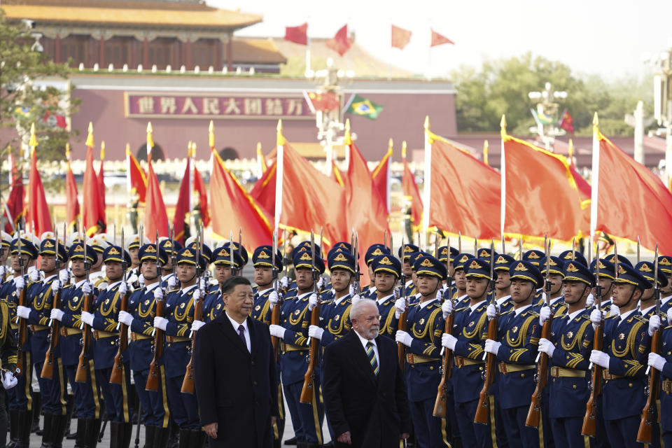 Brazilian President Luiz Inacio Lula da Silva, right, inspects an honor guard with Chinese President Xi Jinping during a welcome ceremony outside the Great Hall of the People in Beijing Friday, April 14, 2023. (Ken Ishii/Pool Photo via AP)