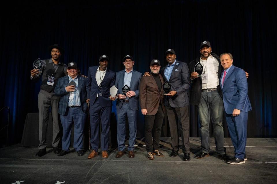 Members of the 1989 Seton Hall men's basketball team join organizer Fred Hill Jr. (fourth from right) and emcee Bruce Beck (far right) at New Jersey's inaugural 'The Basketball Reunion" at Prudential Center in Newark on Monday, April 4, 2022.