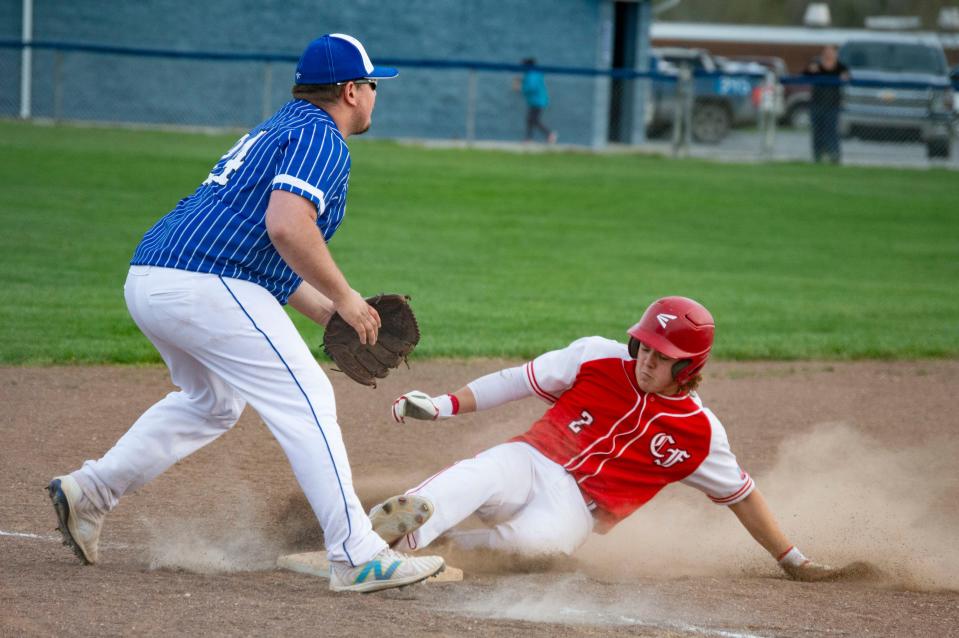 Camden-Frontier junior Kaiden Conroy slides safely into third before an error on the throw would send him home to score the tying run.