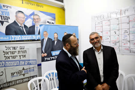 Michael Ben-Ari from the Jewish Power party chats with his party's member Baruch Marzel in Jerusalem, March 17, 2019. REUTERS/Ronen Zvulun