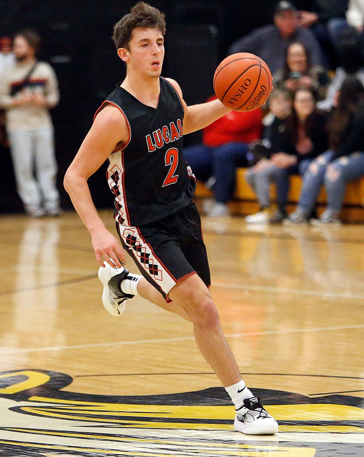 Lucas High School's Logan Toms (2) brings the ball down court against Colonel Crawford High School during high school boys basketball action Saturday, Jan. 13, 2024 at Colonel Crawford High School.