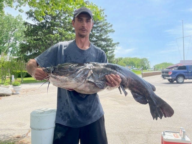 Lloyd Tanner, of Hobart, Indiana, was fishing the St. Joe River in Berrien County in the early-morning hours of Sunday, May 29, 2022, when he caught a flathead catfish weighing 53.35 pounds and measuring 48 inches