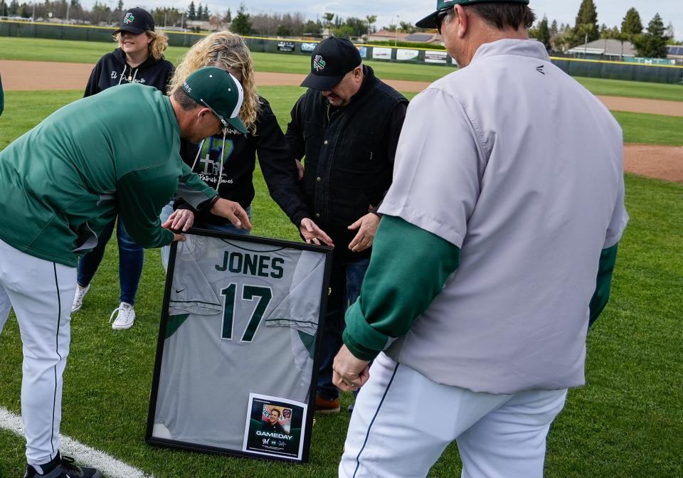 The family of fallen firefighter Patrick Jones, a former El Diamante baseball player, is presented with a jersey as well as a banner on the right field fence.