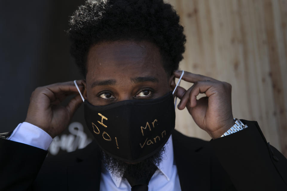 FILE - Tray Vann wears a mask made by his bride, after their marriage service in Anaheim, Calif., on May 26, 2020. Now that weddings have slowly cranked up under a patchwork of ever-shifting restrictions, horror stories from vendors are rolling in. Many are desperate to work after the coronavirus put an abrupt end to their incomes and feel compelled to put on their masks, grab their cameras and hope for the best.(AP Photo/Jae C. Hong, File)