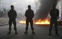 Tyres are set on fire during a rally held by members of the far-right radical group Right Sector, representatives of the Ukrainian volunteer corps and their supporters in central Kiev, Ukraine, in this July 3, 2015 file photo. REUTERS/Valentyn Ogirenko/Files