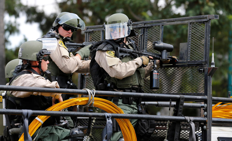 <p>Los Angeles Sheriff Department deputies stand behind a truck-mounted barrier with nonlethal weapons to disperse demonstrators after Republican presidential candidate Donald Trump spoke at a campaign rally in Anaheim, Calif., on May 25, 2016. (Reuters/Mike Blake) </p>