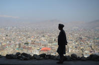 <p>An Afghan man walks during the first day of the Nowruz (Noruz), or Persian New Year, in a hilltop overlooking of Kabul on March 21, 2018. (Photo: Shah Marai/ AFP/Getty Images) </p>