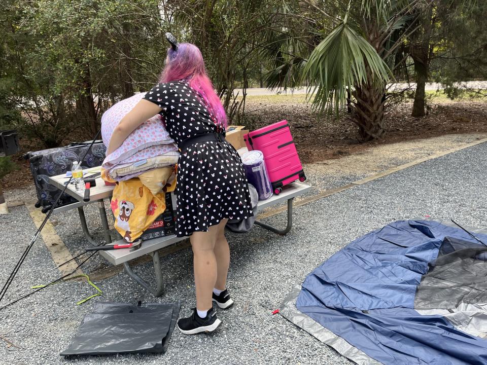 jenna clark handling camping gear on picnic table