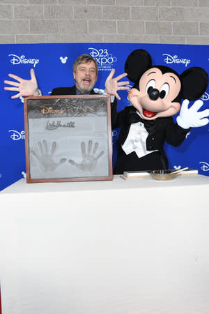 <p>The <em>Star Wars</em> star’s handprints are immortalized in concrete during the Disney Legends ceremony. (Photo: Disney) </p>