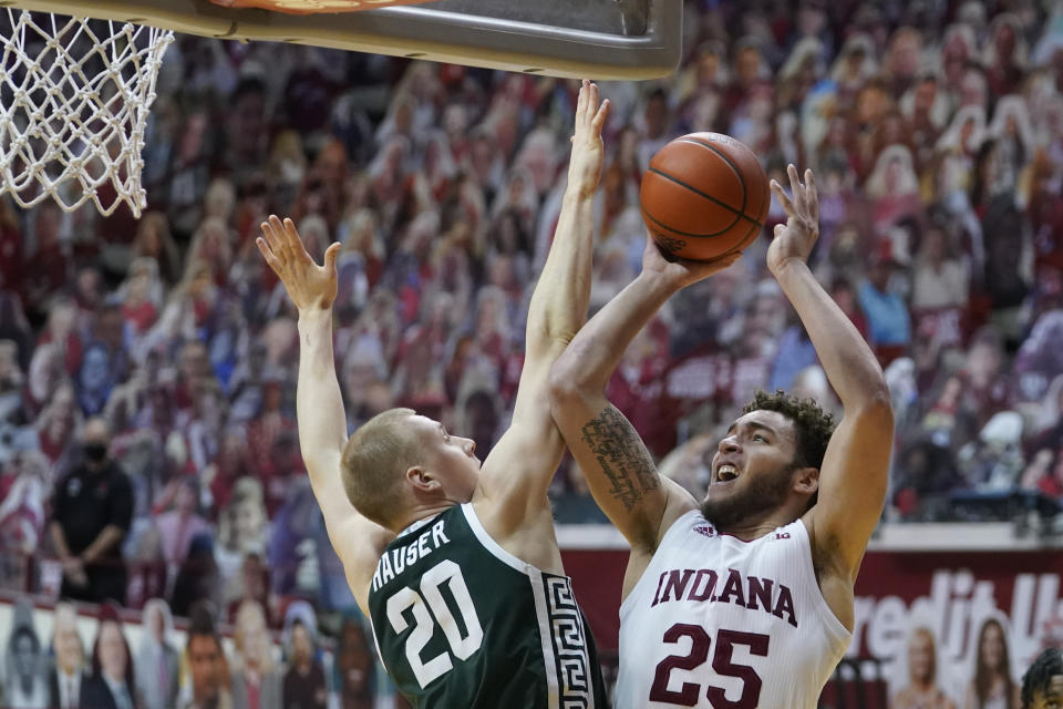 Indiana's Race Thompson (25) shoots over Michigan State's Joey Hauser (20) during the second half of an NCAA college basketball game, Saturday, Feb. 20, 2021, in Bloomington, Ind. Michigan State won 78-71. (AP Photo/Darron Cummings)