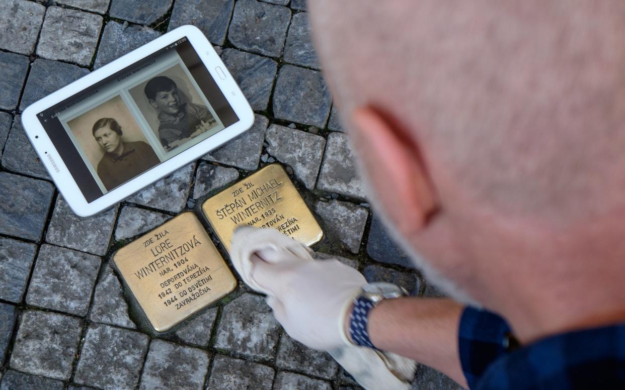 Trevor Sage regularly takes to the streets of Prague to clean the 311 stones that mark where a Holocaust victim once lived  - Â© 2018 James Fassinger