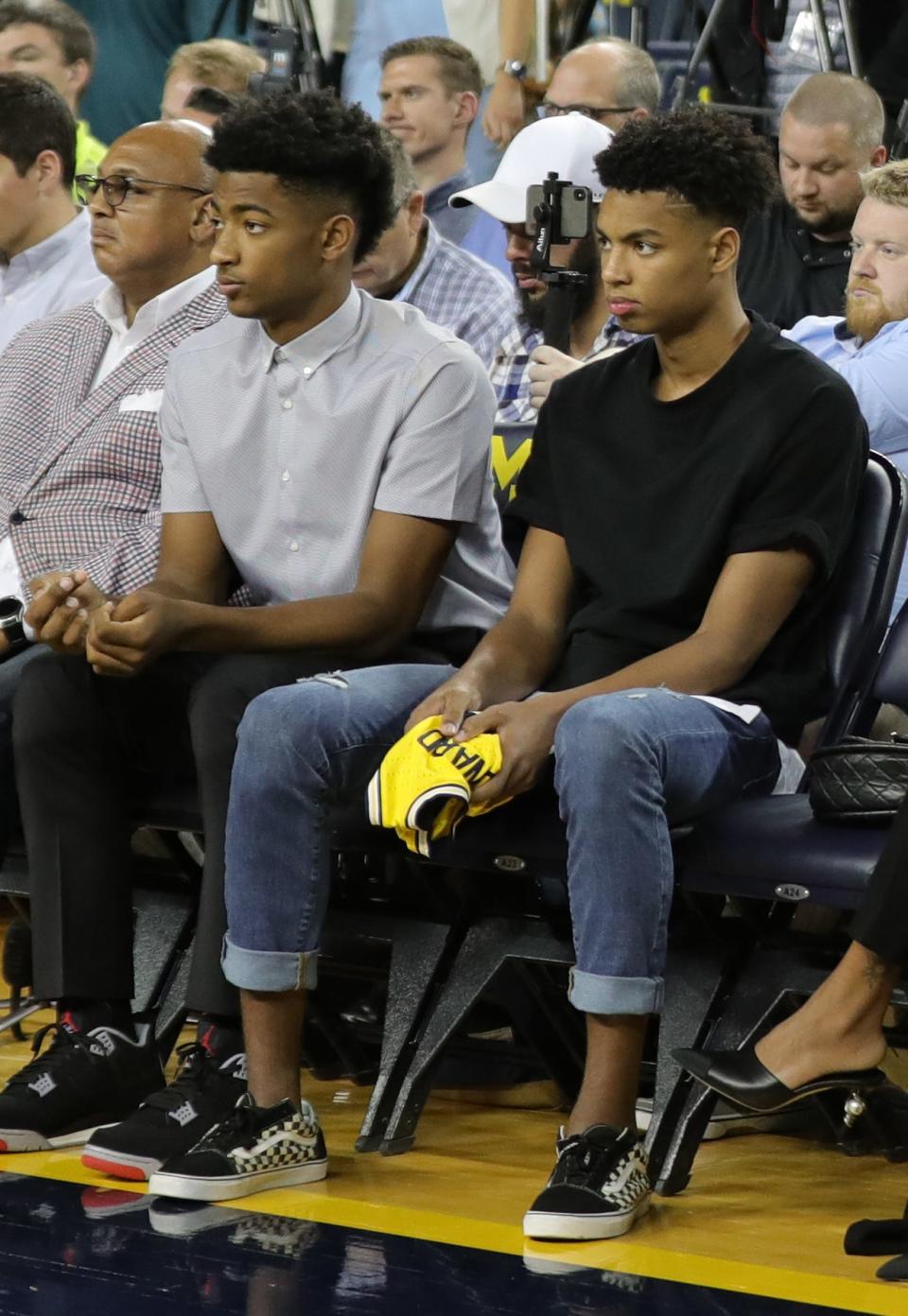 Jace Howard and his brother Jett Howard listen as their dad,  Juwan Howard,  the new Michigan mens basketball coach  takes questions on May 30, 2019 at the Crisler Center in Ann Arbor.