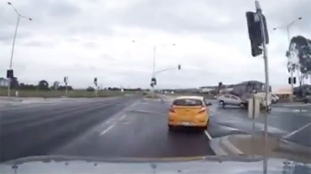 The silver hatchback seems to appear out of nowhere and smash into the ute. Photo: Dash Cam Owners Australia