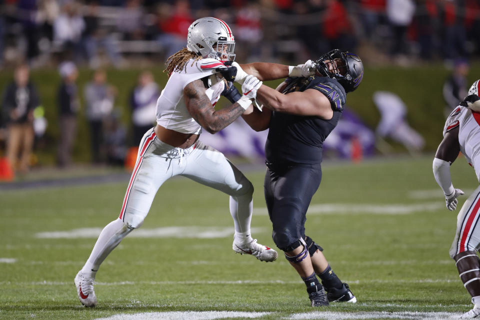 File-This Oct. 18, 2019, file photo shows Ohio State defensive end, Chase Young, left, engaging Northwestern offensive lineman Rashawn Slater during the second half of an NCAA college football game in Evanston, Ill. Caleb Farley of Virginia Tech was the first top prospect to make the decision that has added a whole new layer of uncertainty to the annual crapshoot that is the NFL draft. Farley had plenty of players follow his lead, including several others set to be high draft picks next week like LSU receiver Chase, Oregon tackle Penei Sewell, Northwestern tackle Slater, and Penn State linebacker Micah Parsons.(AP Photo/Charles Rex Arbogast, File)