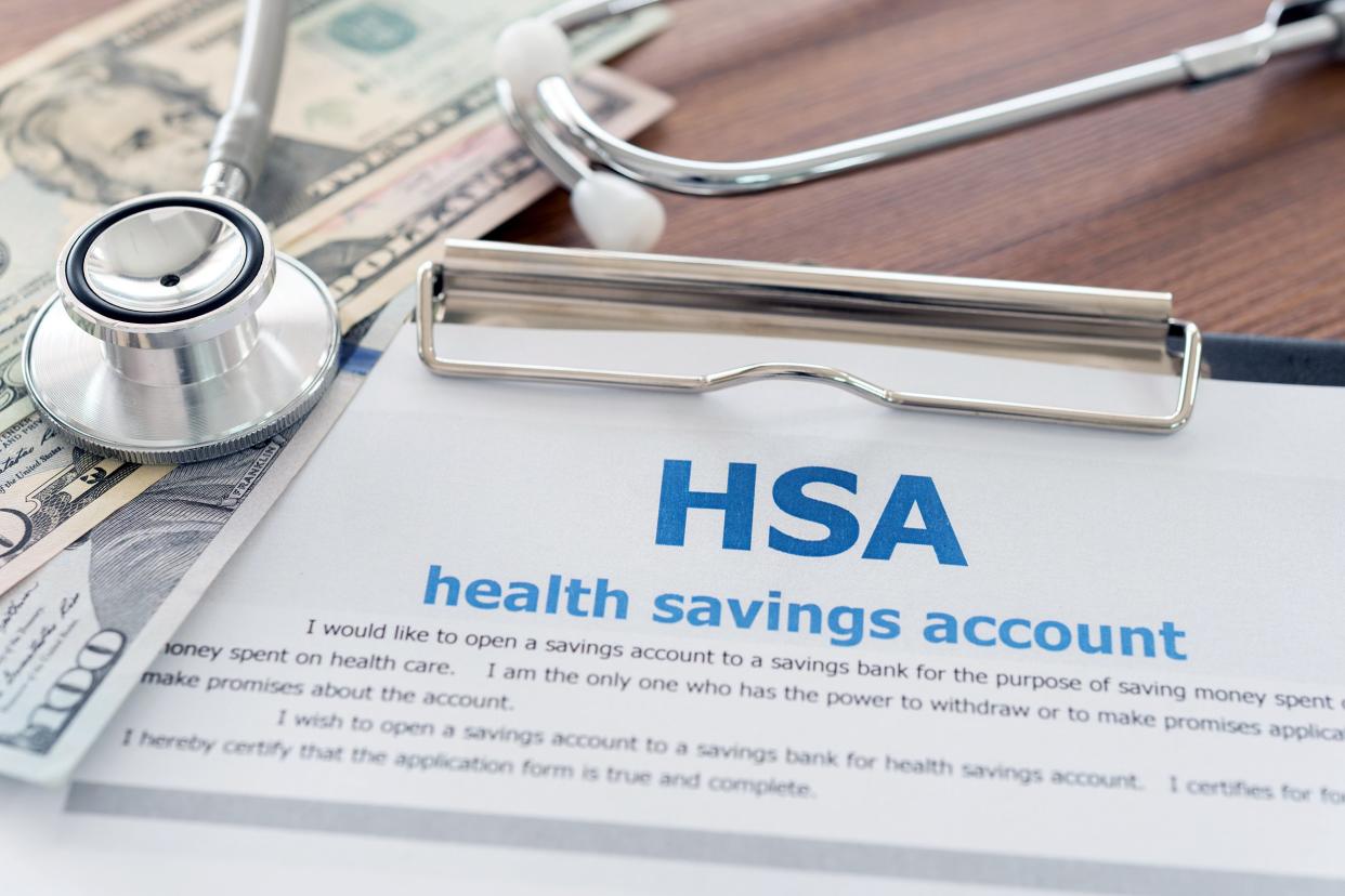 HSA application form, dollar money, and stethoscope on desk