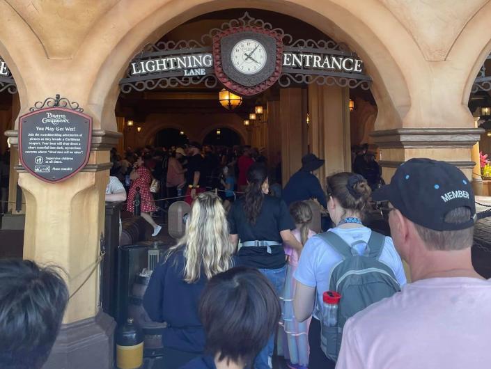 lightning lane line outside pirates of the carribean at disney world