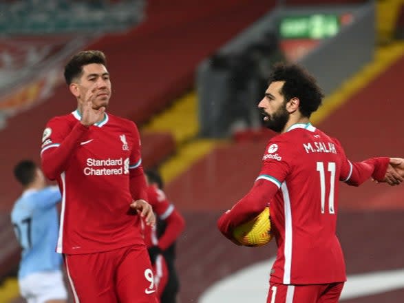 Mohamed Salah is congratulated by Roberto Firmino (Getty)