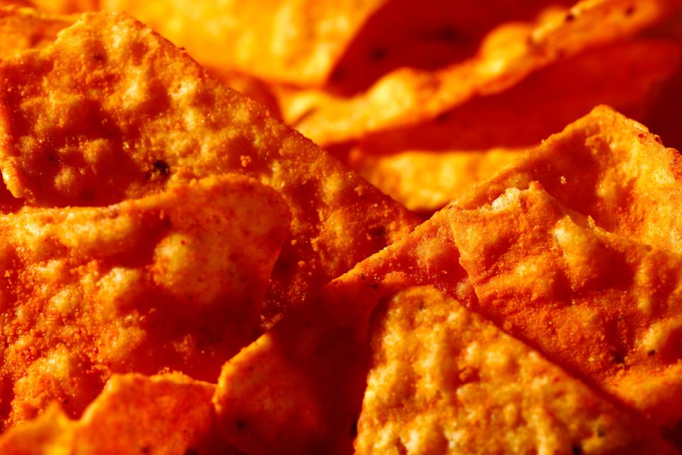 This Sept. 26 photo shows Nacho Cheese flavored Doritos in Philadelphia. “Artificial and natural flavors” have become ubiquitous terms on food labels, helping create vivid tastes that would otherwise be lost in mass production. As the science behind them advances, however, some are calling for greater transparency about their safety and ingredients.