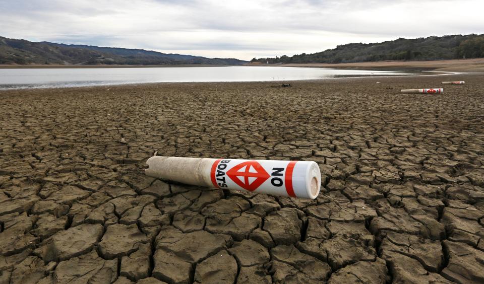 A warning buoy sits on the dry, cracked bed of Lake Mendocino on Feb. 4, 2014, near Ukiah, Calif.  Megadroughts could plague much of the USA because of climate change, according to a study.