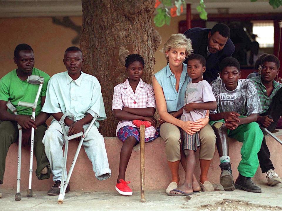 Diana, Princess Of Wales, with children injured by mines at Neves Bendinha Orthopaedic Workshop in Luanda, Angola, in 1997.