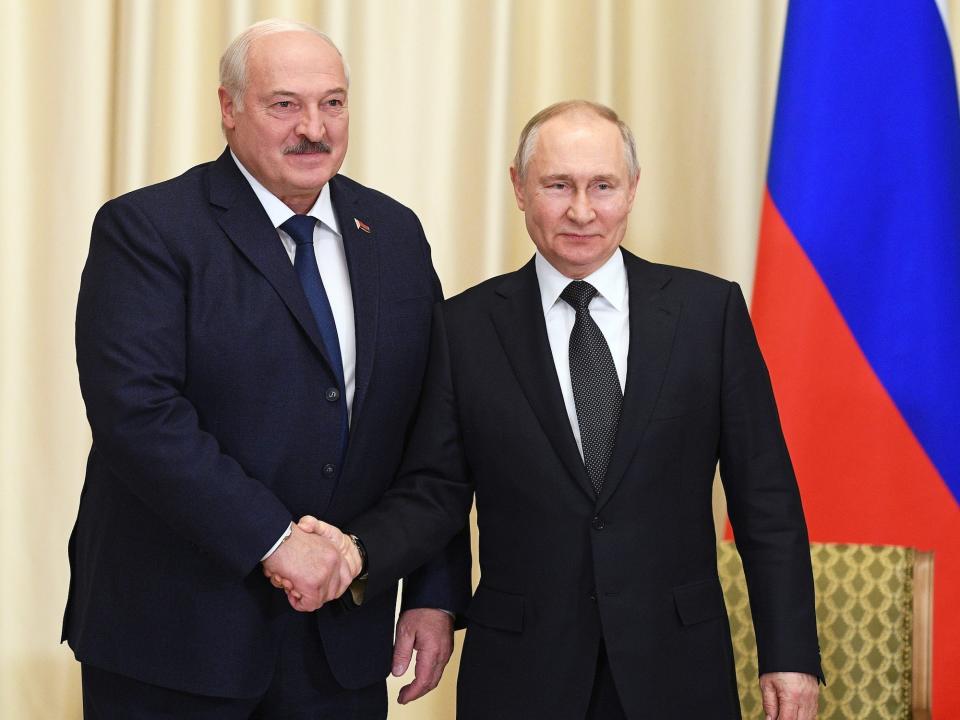 Russian President Vladimir Putin, right, and Belarusian President Alexander Lukashenko shake hands during their meeting at the Novo-Ogaryovo state residence, outside Moscow, Russia, Friday, Feb. 17, 2023