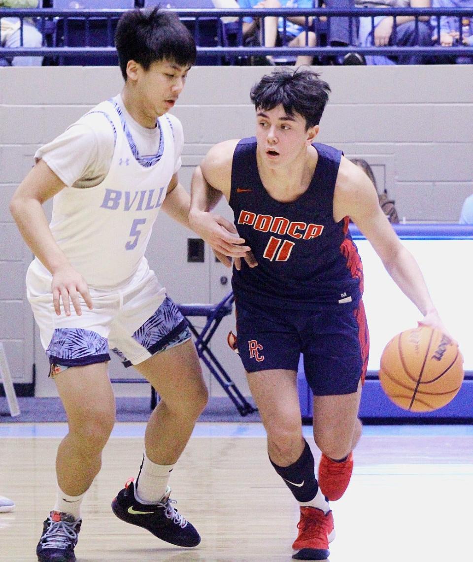 Bartlesville HIgh's Riley Duong, left, pressures a Ponca City dribbler  during Bartlesville tourney action on Jan. 5, 2023.