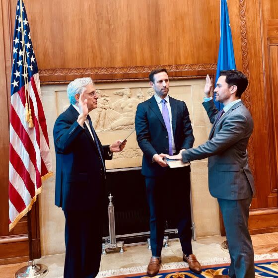 Attorney General Merrick Garland (left) swears in Assistant Attorney General for the Office of Legislative Affairs Carlos Uriarte. The office acts as the ambassador between the department and Capitol Hill. (Department of Justice handout)