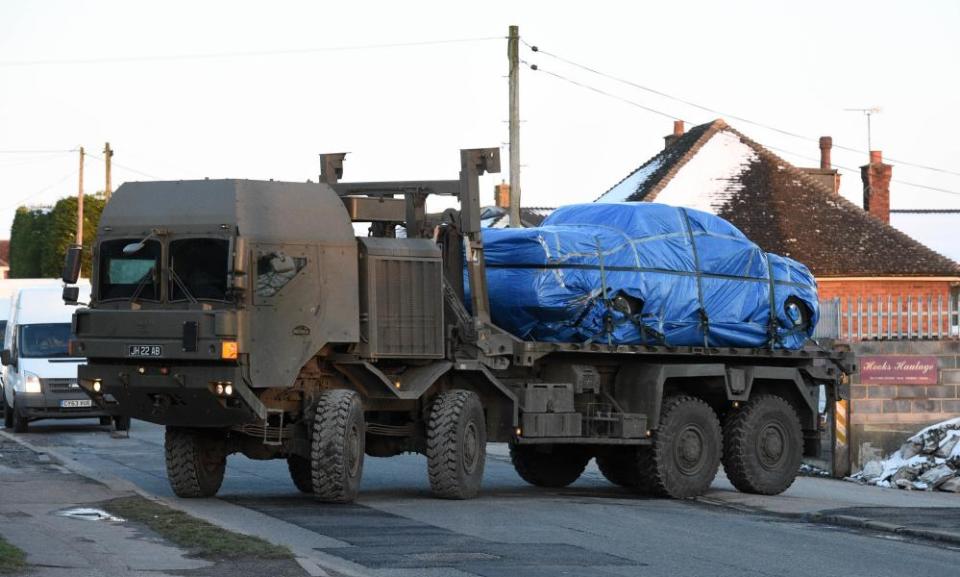 A vehicle is taken away on a military lorry from a road in Durrington, Wiltshire