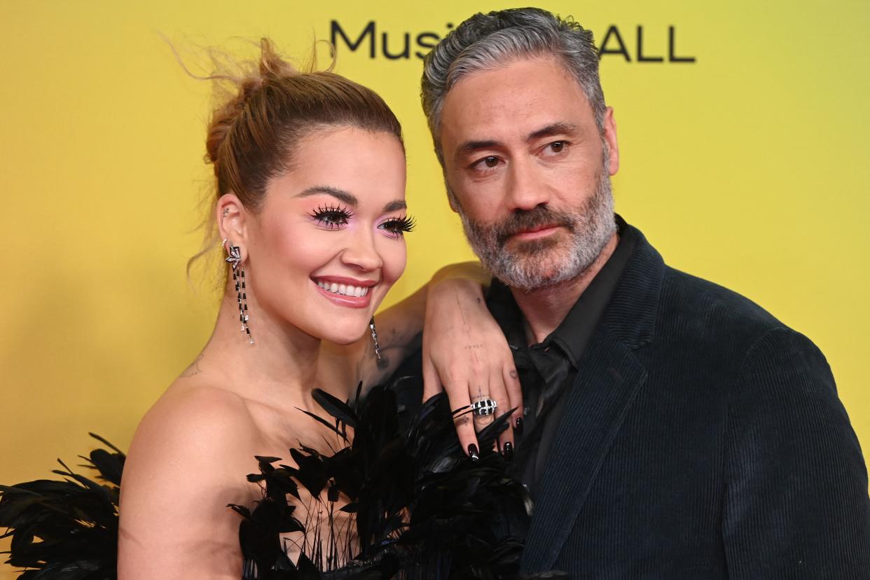 British singer-songwriter Rita Ora poses with New Zealand film director Taika Waititi on the red carpet as she arrives for the MTV Europe Music Awards at the Laszlo Papp Budapest Sports Arena in Budapest, Hungary on November 14, 2021. (Photo by Attila KISBENEDEK / AFP) (Photo by ATTILA KISBENEDEK/AFP via Getty Images)