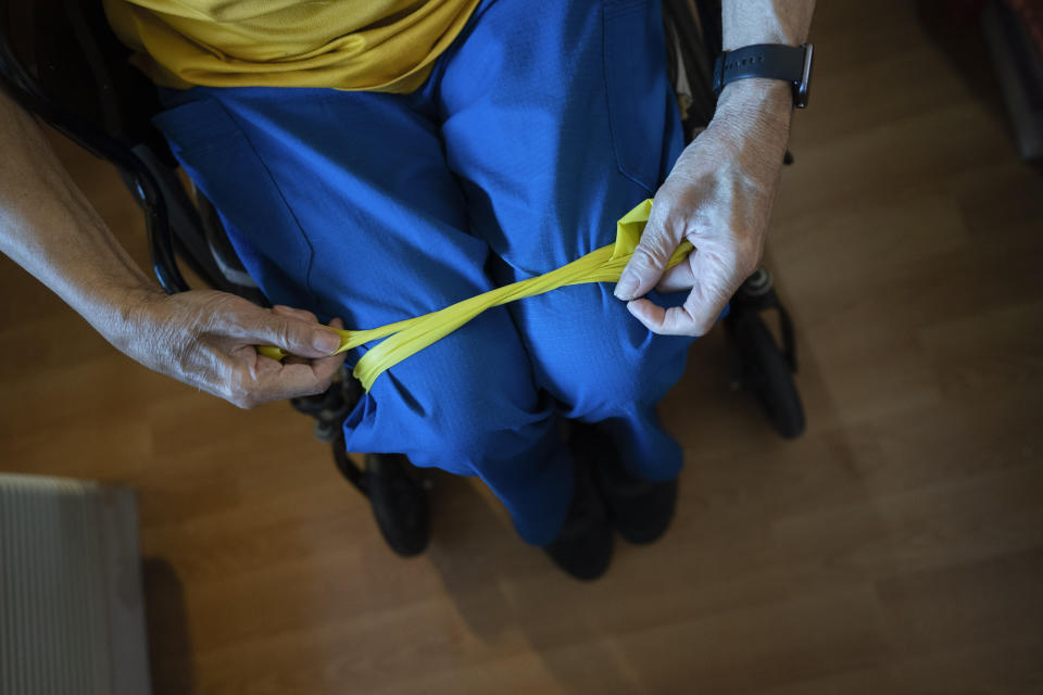 Alex Morisey does his afternoon exercises using a resistance band in his room at a nursing home in Philadelphia, on Wednesday, Feb. 15, 2023. He ended up in a nursing home after a fall and, once here, learned his income would no longer be his. Pennsylvania’s allowance is $45, and after a monthly $20 haircut and $5 tip, a juggling act begins. (AP Photo/Wong Maye-E)