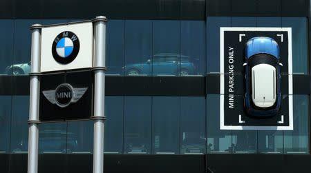 A Mini car is fixed onto a wall at a BMW and Mini dealership in Barcelona, Spain June 2, 2017. REUTERS/Albert Gea