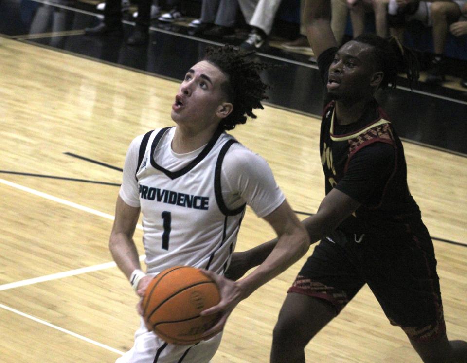 Providence guard Chris Arias (1) goes up for a layup against Florida High  during the FHSAA Region 1-3A boys basketball final on February 24, 2023. [Clayton Freeman/Florida Times-Union]