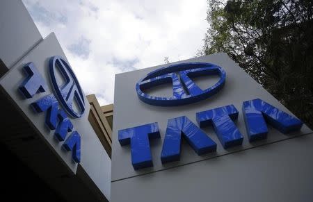 Tata Motors logos are seen at their flagship showroom before the announcement of their Q3 results in Mumbai February 14, 2013. REUTERS/Vivek Prakash/Files