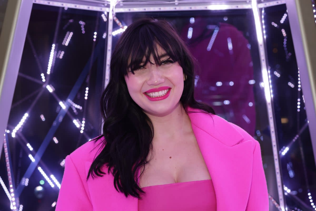 Daisy Lowe wore a bright pink Valentino bralette and high-waisted trousers to the festive event in London  (Dave Benett)