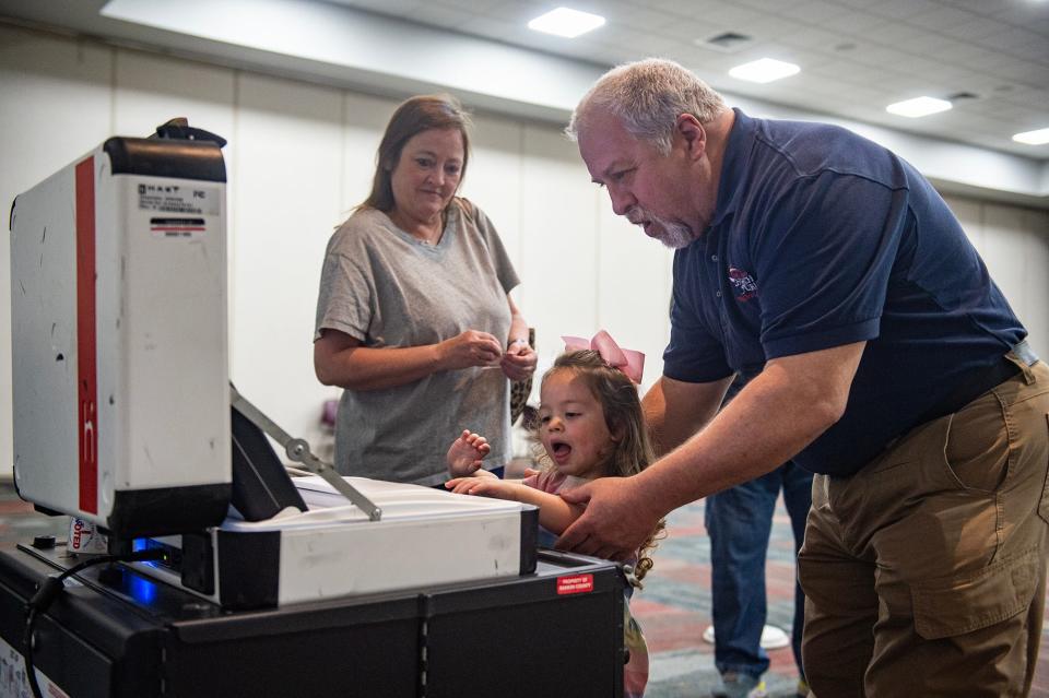 Nan and Darrel Cockroft help their granddaughter Berklee Smith, 3, cast a ballot for the primary election at Richland Community Center in Richland, Miss., on Tuesday, Mar. 12, 2024.