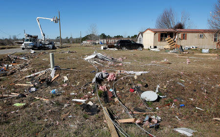 Power workers work on reinstalling power lines at Sunshine Acres mobile home park after a tornado struck the mobile home park in Adel, Georgia, U.S., January 24, 2017. REUTERS/Tami Chappell