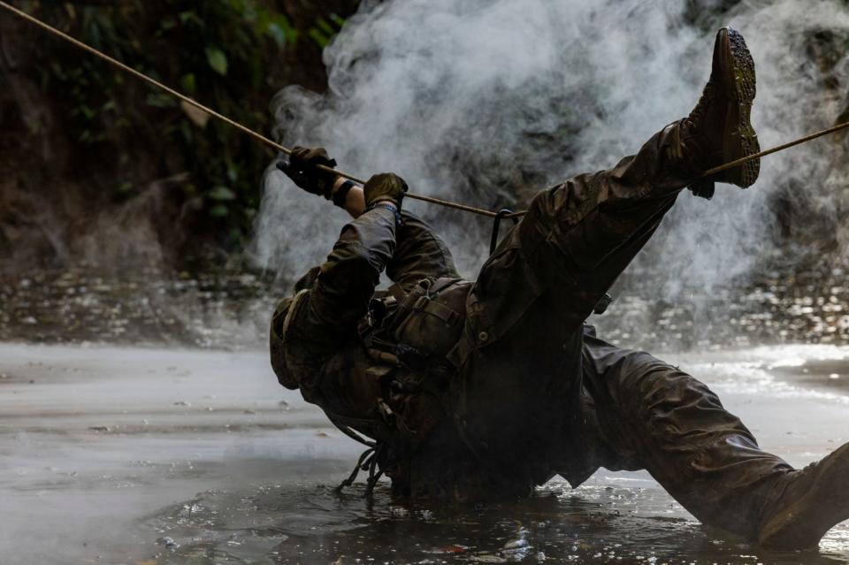 A Marine Raider with Marine Forces Special Operations Command navigates a single rope bridge during a jungle mobility course, Aug. 4, 2023.