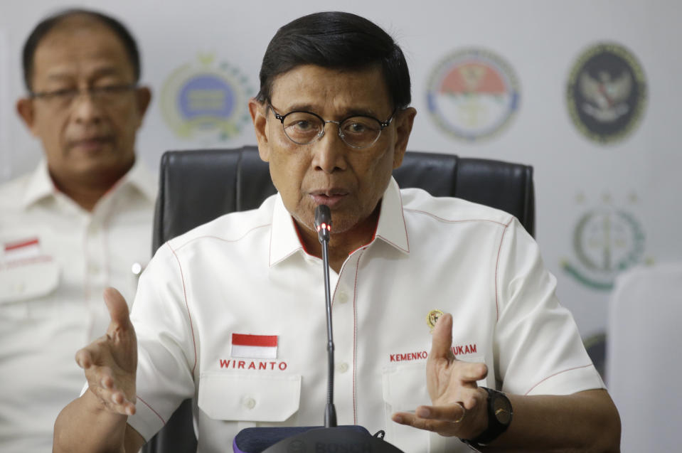 FILE - In this Tuesday, Sept. 24, 2019, file photo, Indonesian Coordinating Minister for Politics, Law and Security Wiranto gestures as he speaks during a press conference in Jakarta, Indonesia. Indonesian police officials say Wiranto and two other people, including a local police chief, have been wounded by a knife-wielding man and taken to a hospital during a visit to a western province. (AP Photo/Achmad Ibrahim, File)