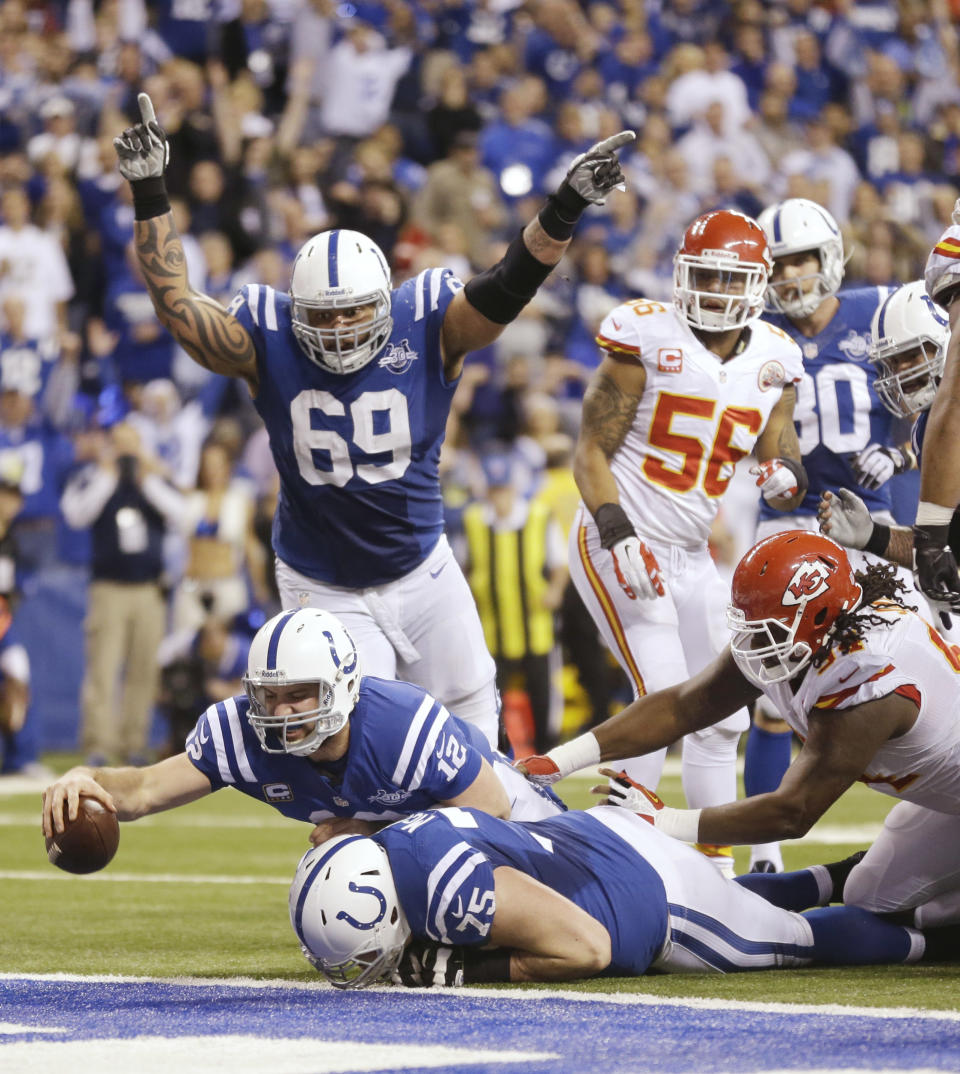 Indianapolis Colts quarterback Andrew Luck (12) dives for a touchdown after recovering a fumble by the Colts' Eric Berry during the second half of an NFL wild-card playoff football game against the Kansas City Chiefs Saturday, Jan. 4, 2014, in Indianapolis. (AP Photo/Michael Conroy)