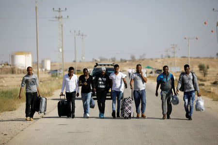 African migrants walk on a road after being released from Saharonim Prison in the Negev desert, Israel April 15, 2018. REUTERS/Amir Cohen