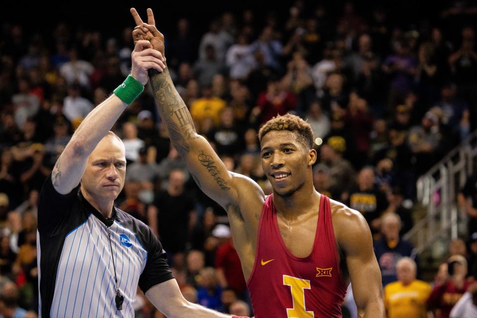 Iowa State's David Carr gets his hand raised by the referee after winning the second NCAA championship of his career Saturday in Kansas City. The Cyclones finished fourth in the team standings.