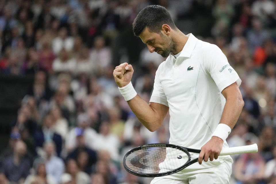 Novak Djokovic of Serbia reacts during his fourth round match against Hulger Rune of Denmark at the Wimbledon tennis championships in London, Monday, July 8, 2024. (AP Photo/Kirsty Wigglesworth)