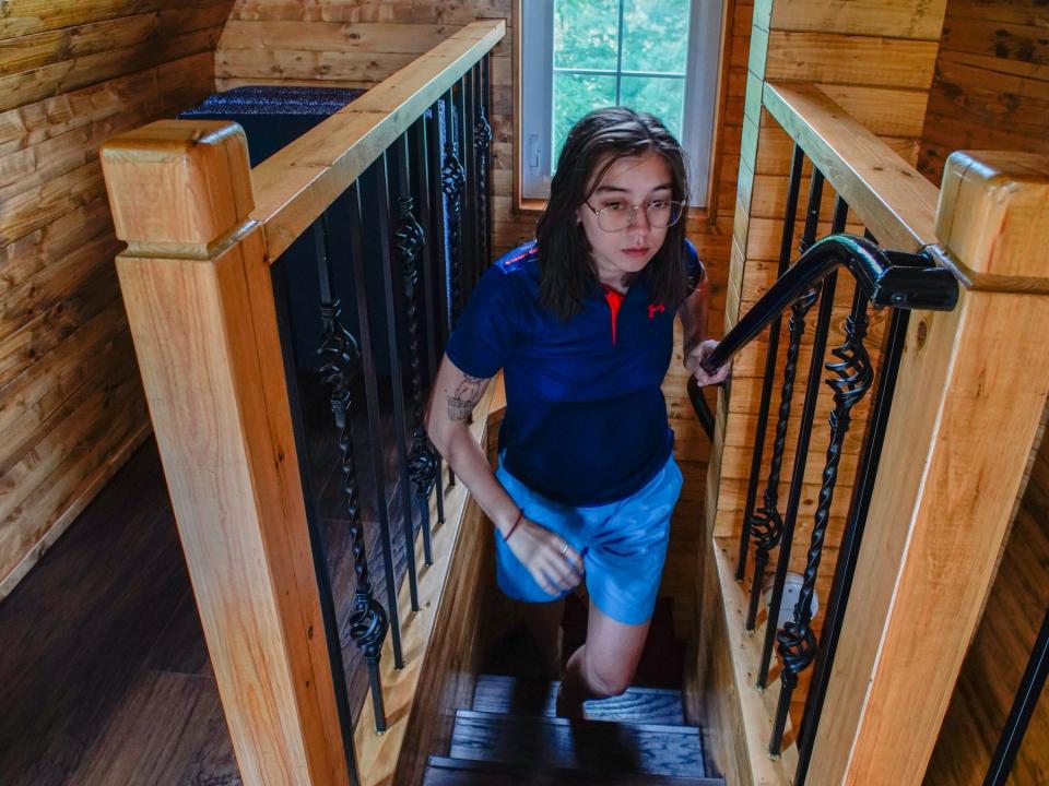 The author walks up the stairs in the treehouse