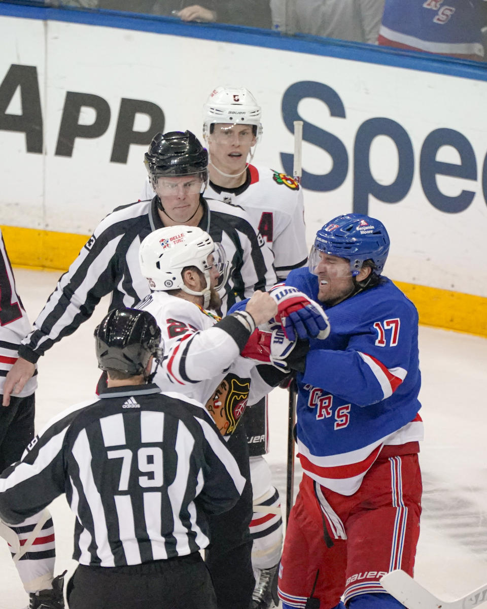 Chicago Blackhawks center Philipp Kurashev (23) and New York Rangers right wing Blake Wheeler (17) fight during the third period of an NHL hockey game in New York, Thursday, Jan. 4, 2024. (AP Photo/Peter K. Afriyie)